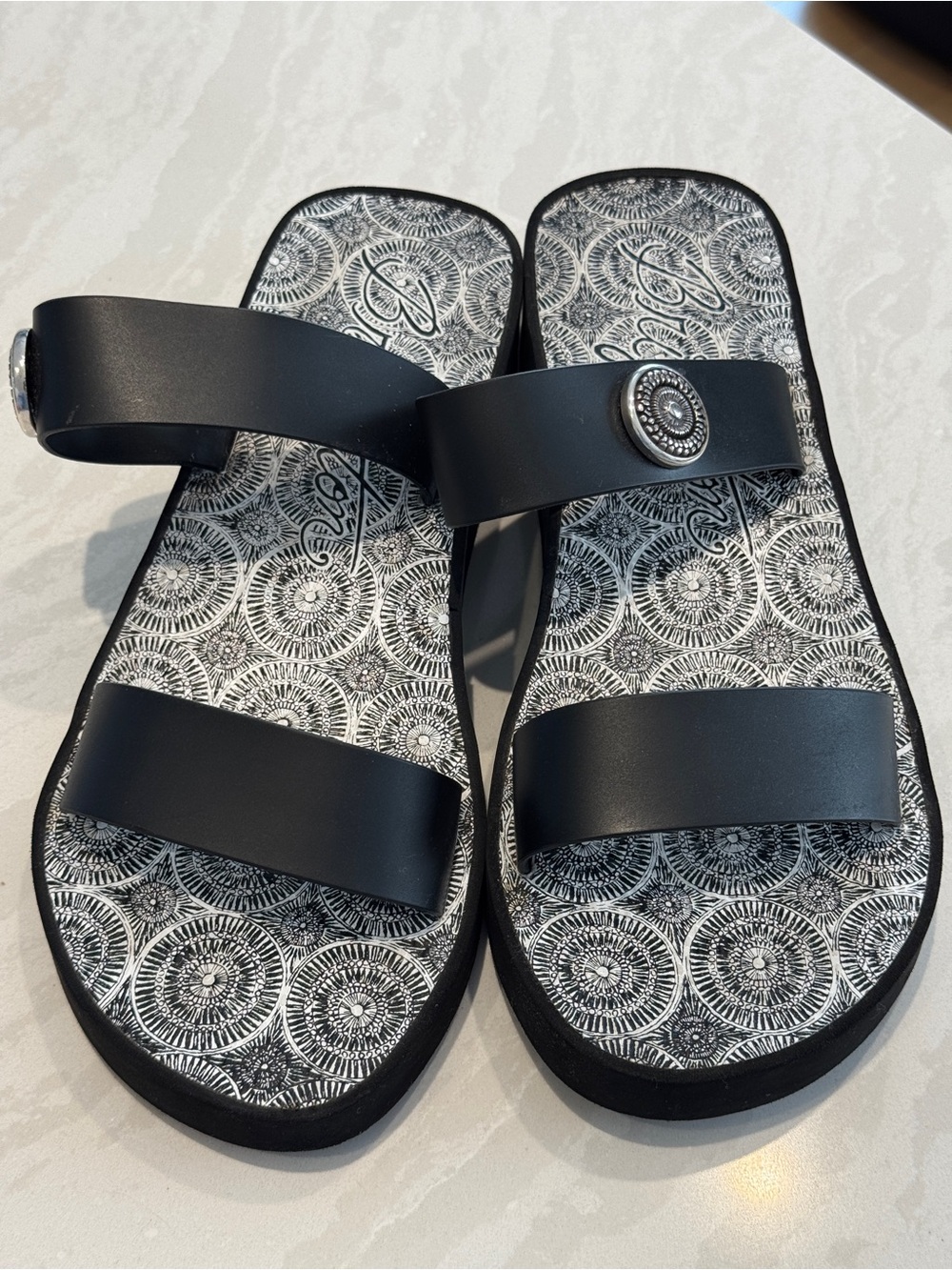 Brighton Black Double-Strap Slide Sandals with Decorative Silver Medallion